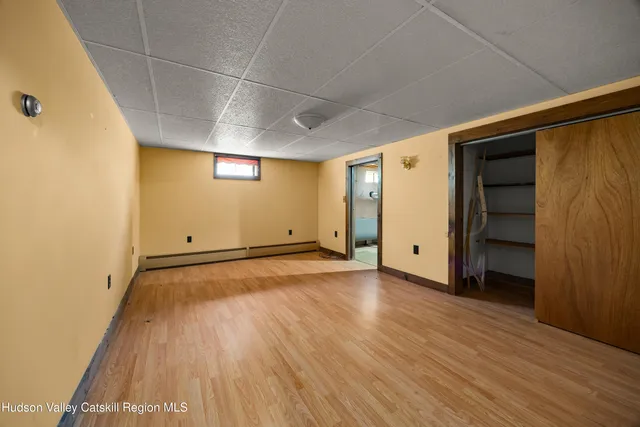 an empty room with wooden floor and closet