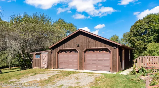 a backyard of a house with table and chairs