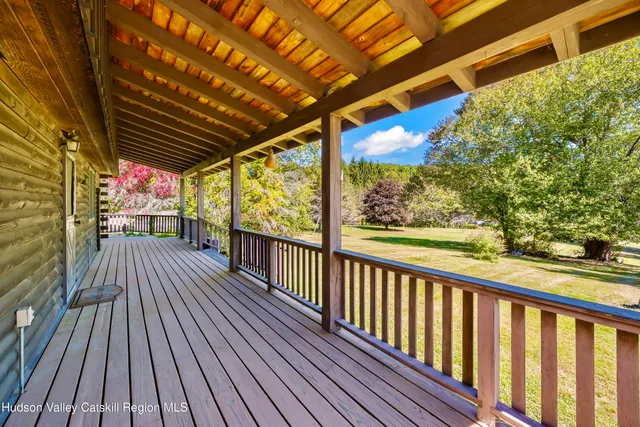 a view of a balcony with wooden floor