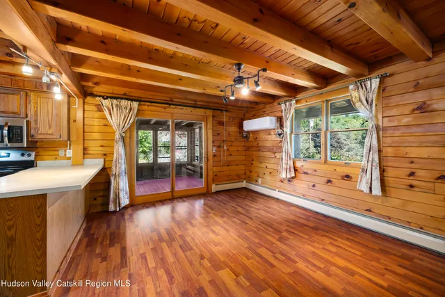 a view of a room with wooden floor and iron stairs