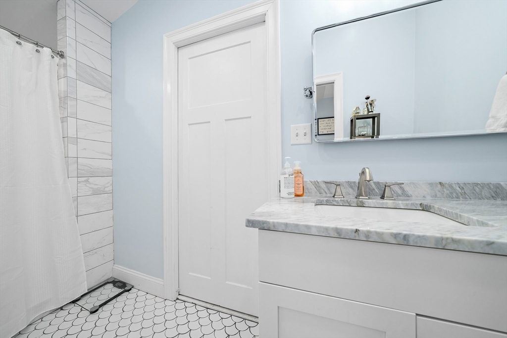 11 Mason Street, Unit 2 Everett, MA 02149 - Photo 7 of 12 a bathroom with a sink and a mirror