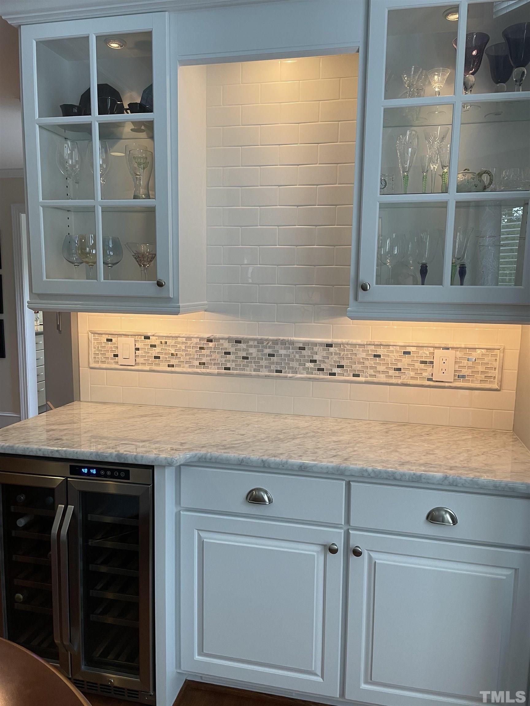 7631 Wellesley Park North Raleigh, NC 27615 - Photo 18 of 88 Take a look at this built-in wine bar--includes the wine fridge and has a Carrara marble countertop