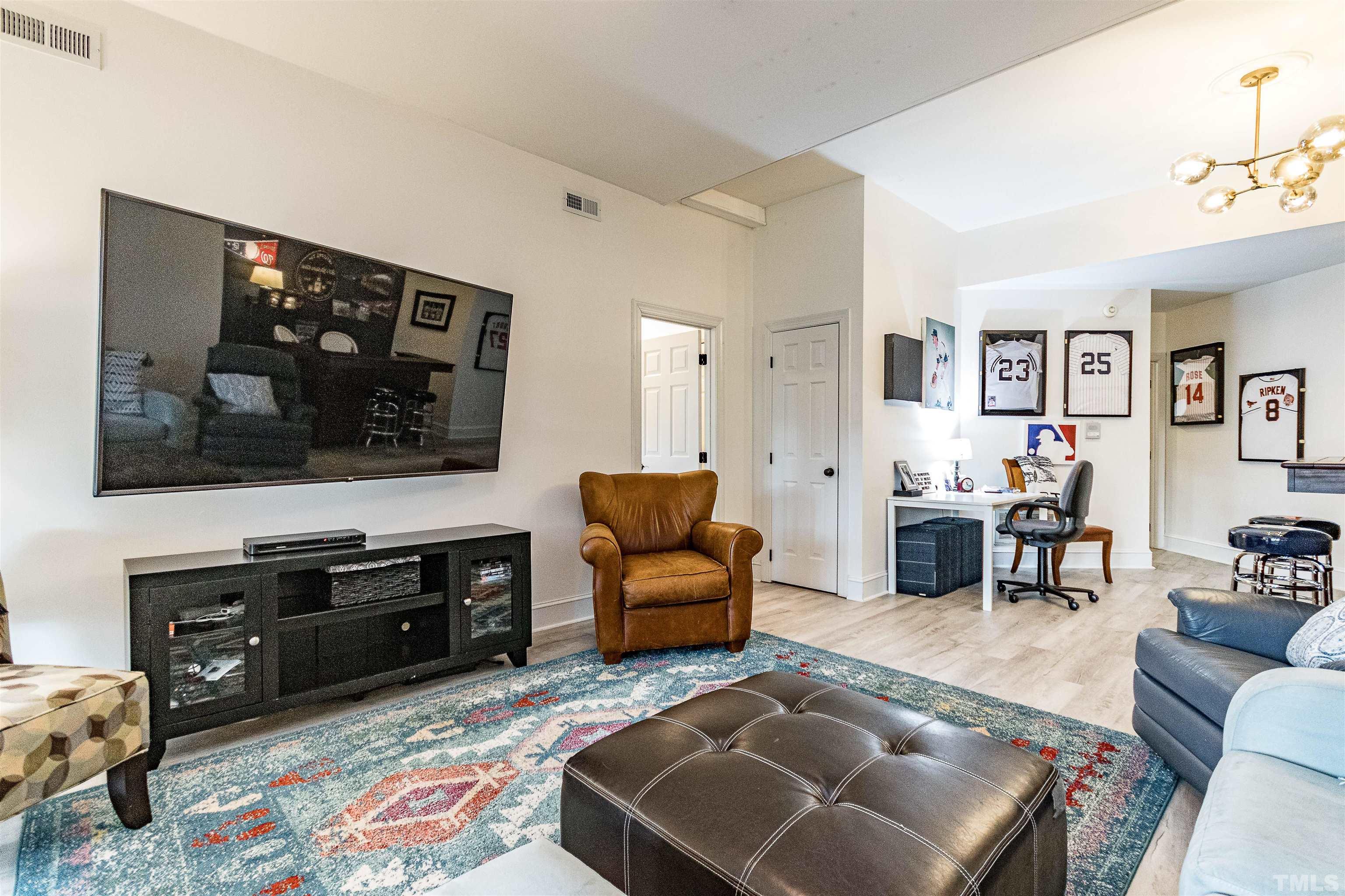 7631 Wellesley Park North Raleigh, NC 27615 - Photo 64 of 88 a living room with furniture and a flat screen tv