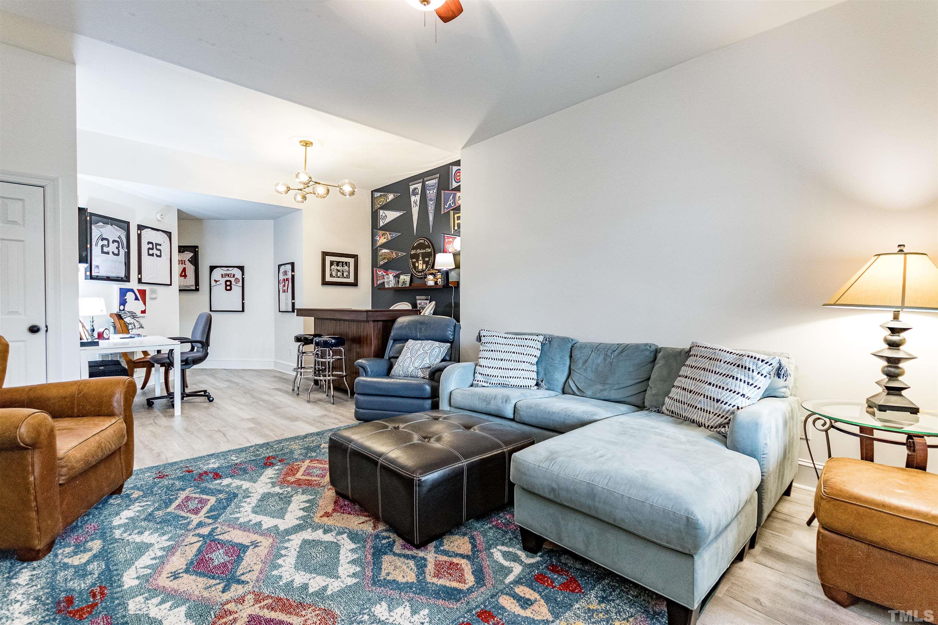 7631 Wellesley Park North Raleigh, NC 27615 - Photo 65 of 88 a living room with furniture a rug and a lamp