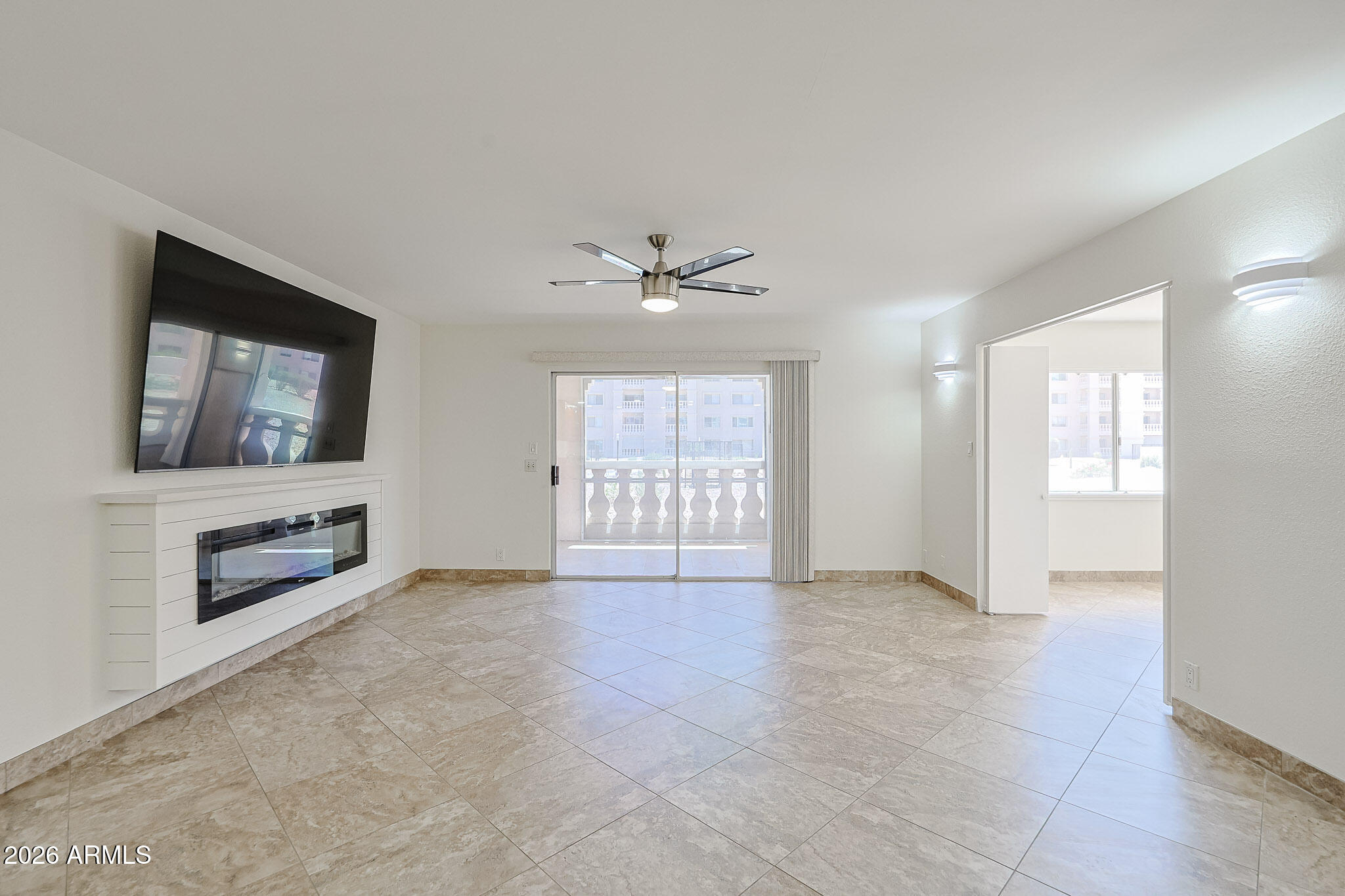 7920 East Camelback Road, Unit 111 Scottsdale, AZ 85251 - Photo 10 of 32 a view of an empty room with a window and a kitchen