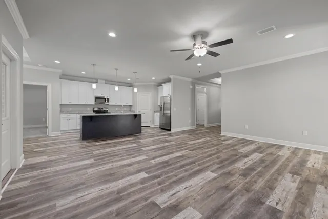 a kitchen with granite countertop a sink stove and refrigerator