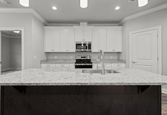 a view of a dining room with furniture a chandelier and wooden floor