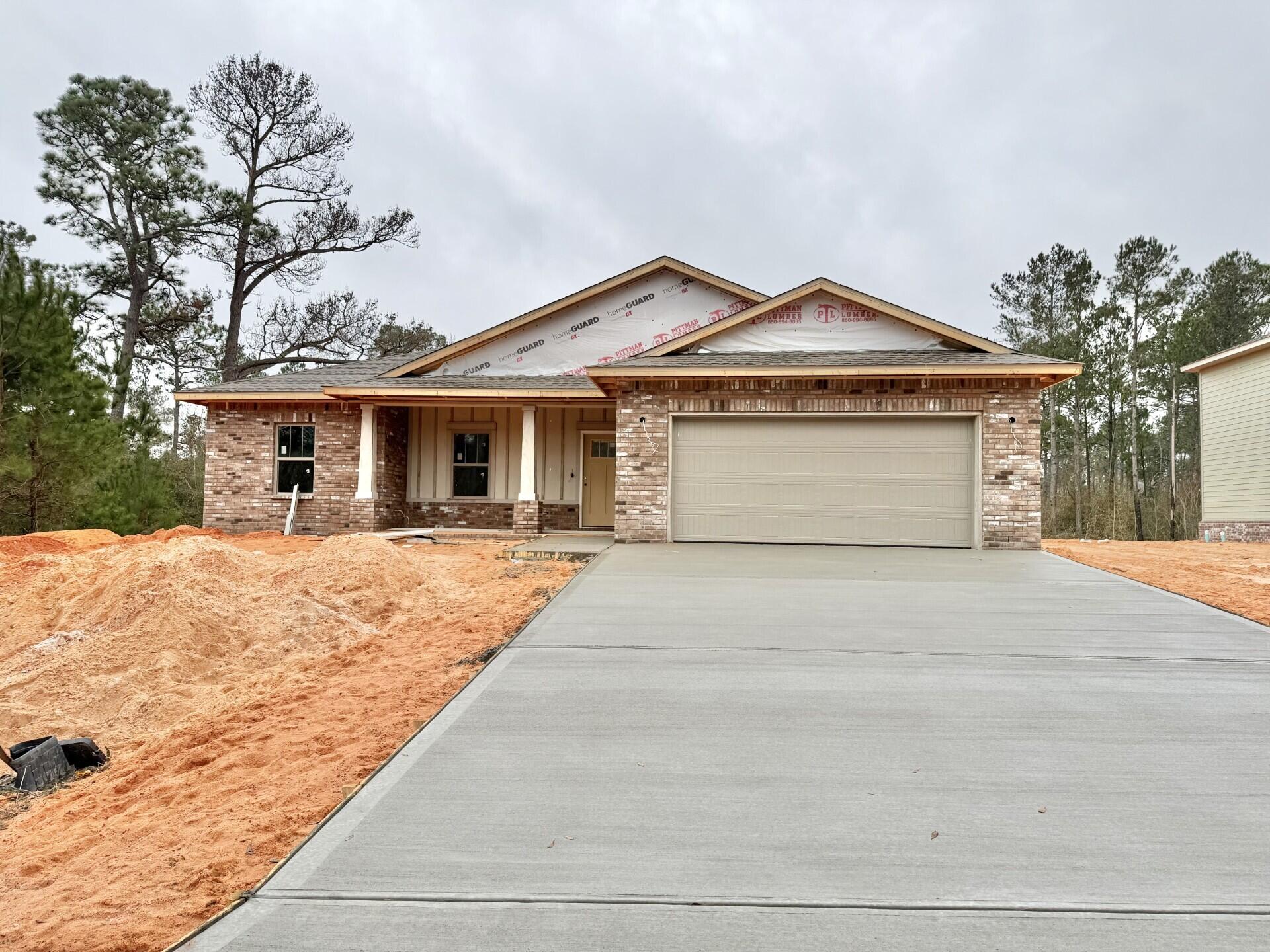 6699 Rocky Shores Road Milton, FL 32583 - Photo 2 of 75 a front view of a house with a yard and garage