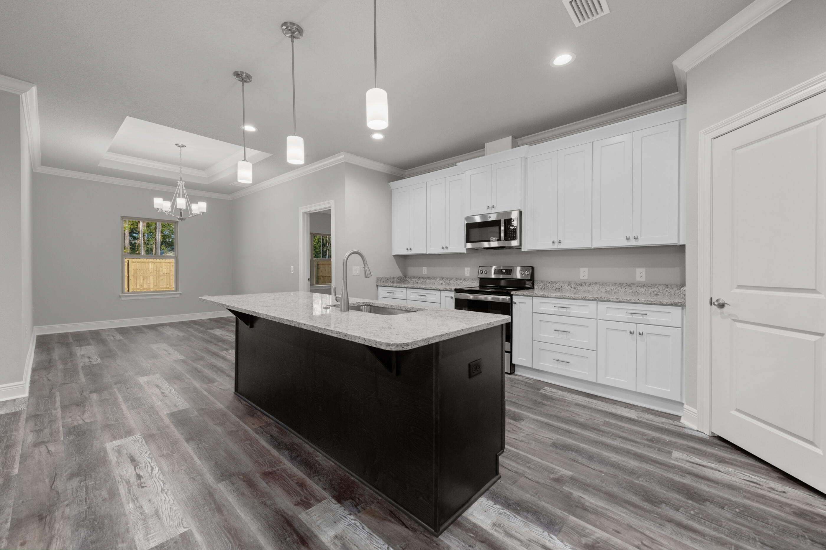 6699 Rocky Shores Road Milton, FL 32583 - Photo 22 of 77 a kitchen with a sink window and cabinets