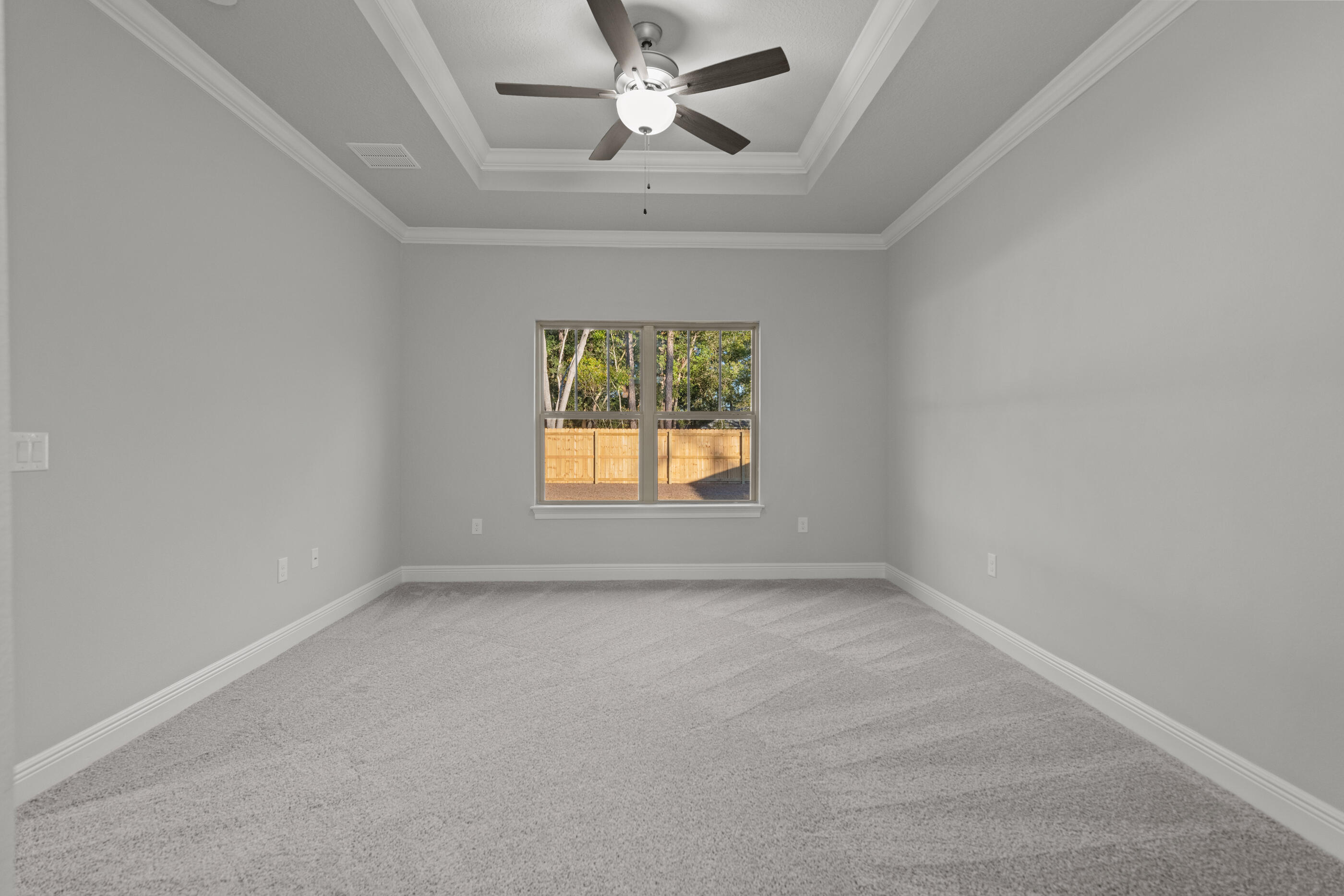6699 Rocky Shores Road Milton, FL 32583 - Photo 32 of 77 an empty room with a window and a ceiling fan