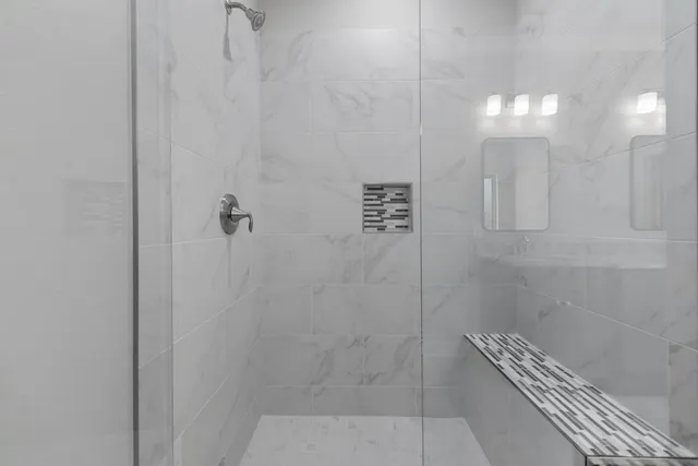 a bed room with a bed couches and a window