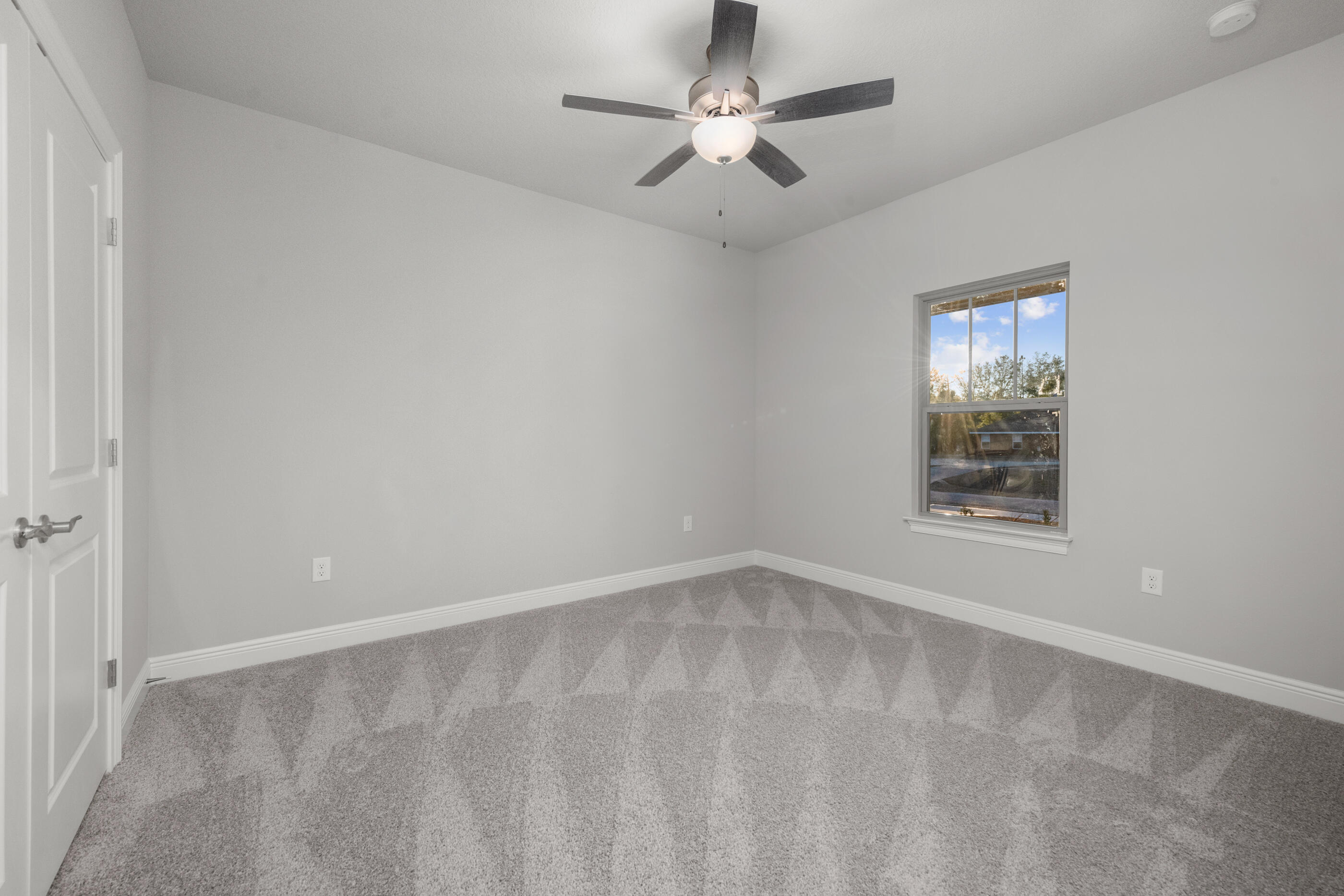 6699 Rocky Shores Road Milton, FL 32583 - Photo 46 of 75 an empty room with a window and a fan