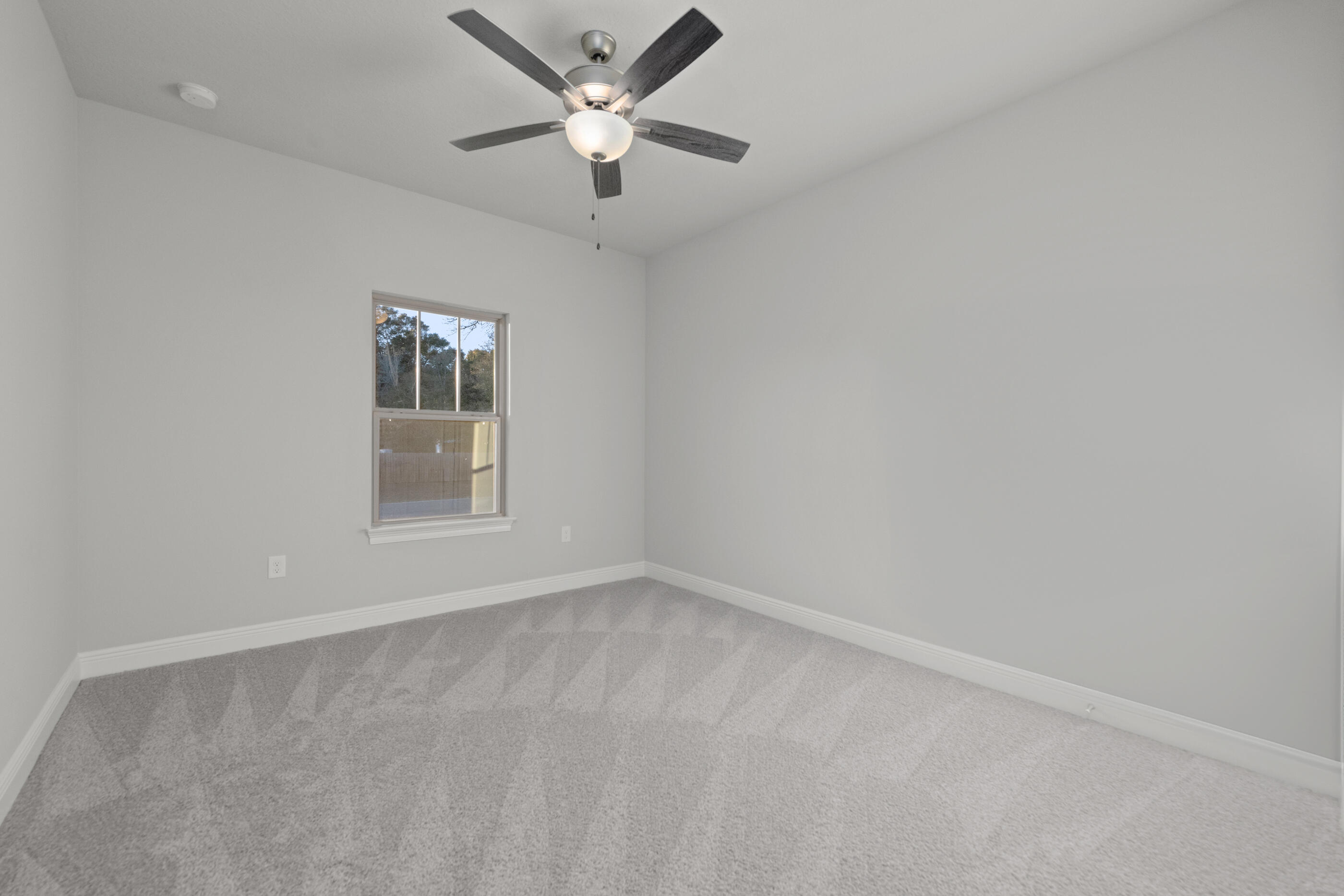 6699 Rocky Shores Road Milton, FL 32583 - Photo 51 of 75 an empty room with a window and ceiling fan