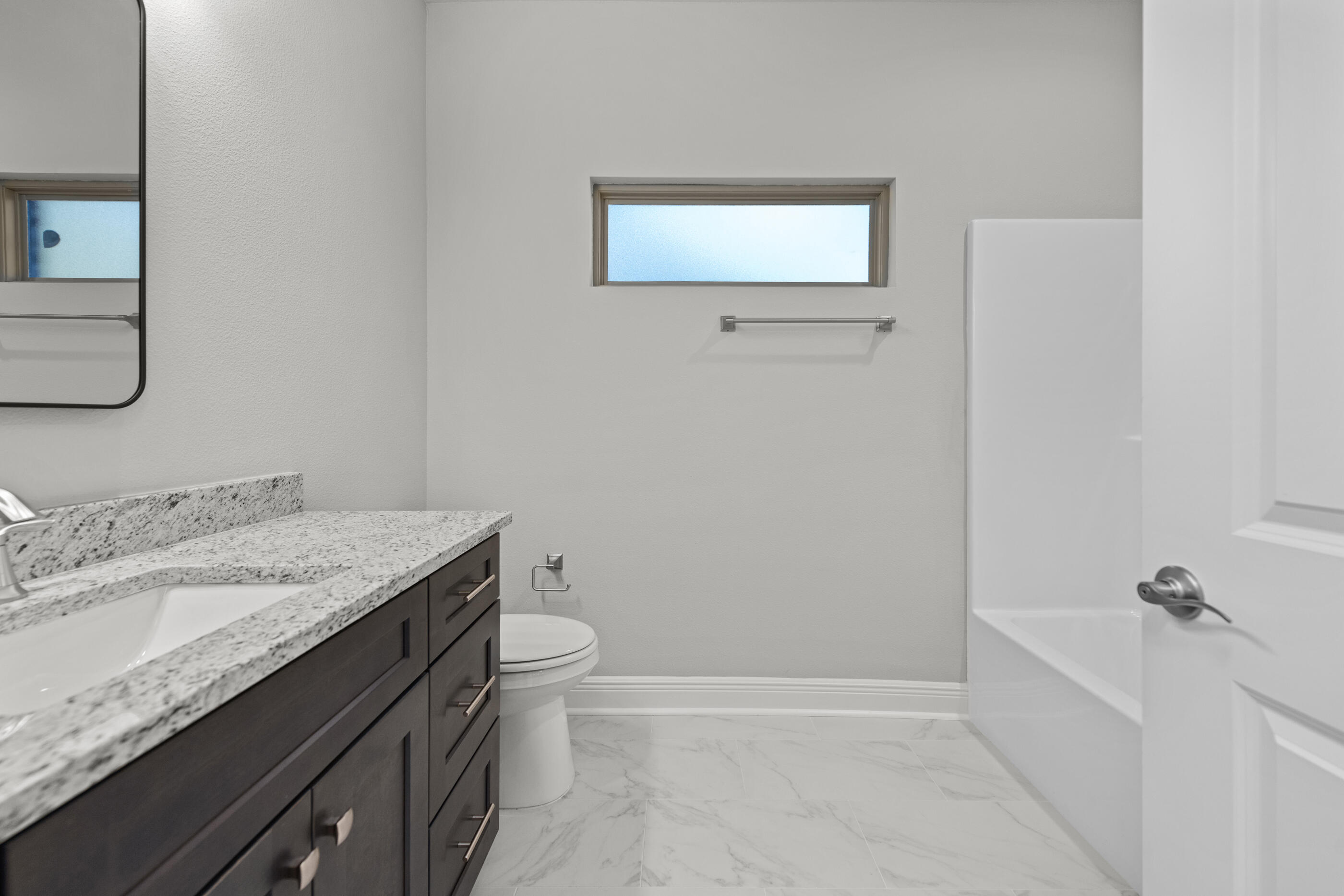 6699 Rocky Shores Road Milton, FL 32583 - Photo 56 of 75 a bathroom with a granite countertop sink toilet and bathtub