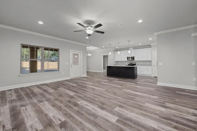 a large white room with a couch and a flat screen tv