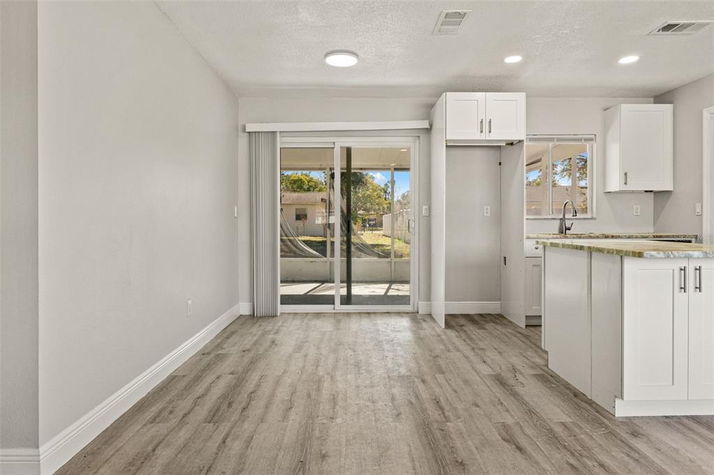 4030 Ligonier Road Spring Hill, FL 34608 - Photo 10 of 33 a view of a kitchen with wooden floor