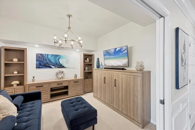 a bedroom with a large bed and a flat tv screen on dresser