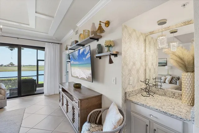 a living room with furniture a chandelier and a flat screen tv
