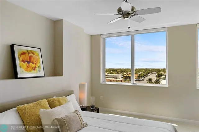 a bedroom with furniture and a large window