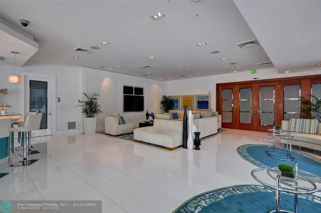 a living room with furniture and large windows