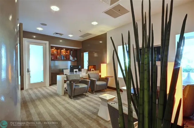 a living room with large window and a wooden floor