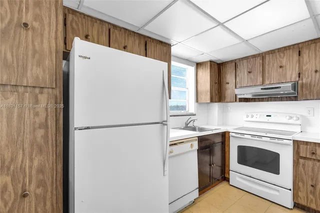 a white refrigerator freezer sitting in a kitchen