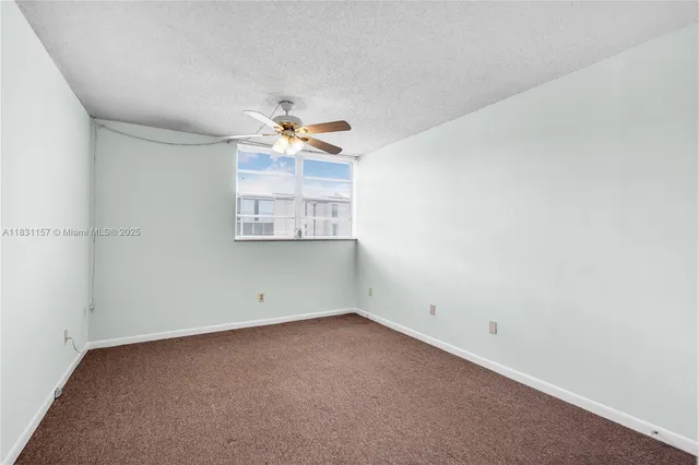 an empty room with a empty space and a ceiling fan