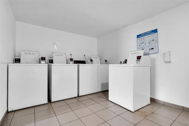 a view of a storage & utility room with dryer and washer