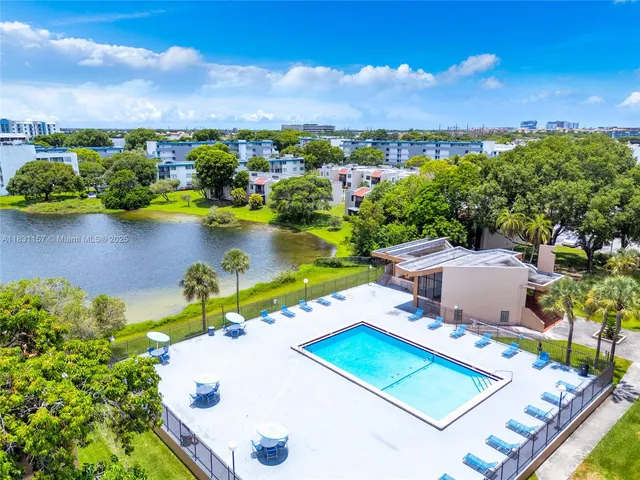 an aerial view of a house a yard swimming pool and outdoor seating