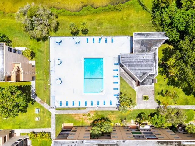 an aerial view of a house with a swimming pool