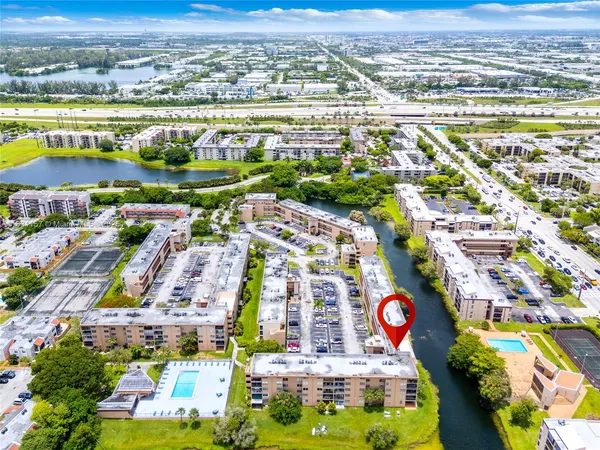an aerial view of residential building and lake