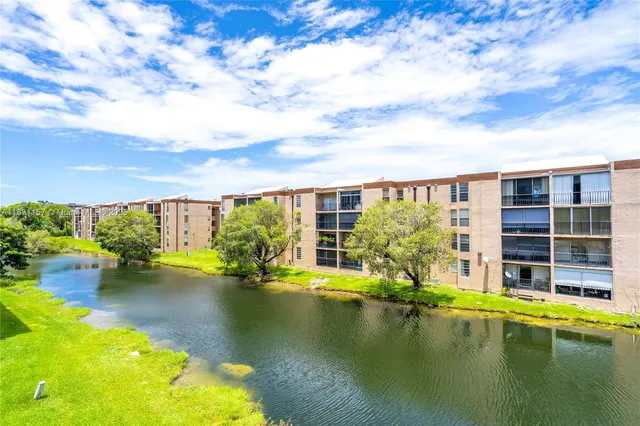 a view of swimming pool with outdoor seating and lake view