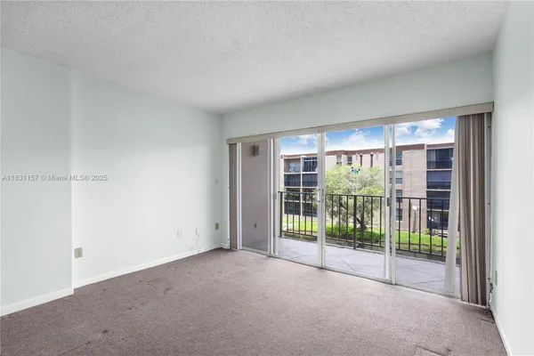 a view of empty room with floor to ceiling window