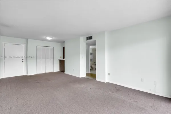 a view of an empty room and a window