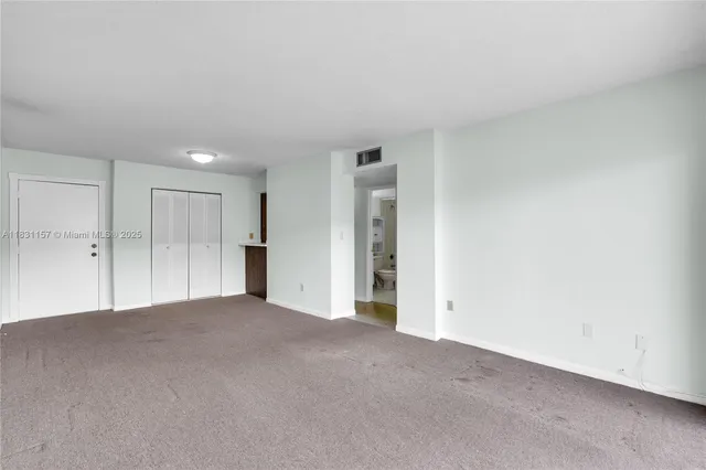 a view of an empty room and a window