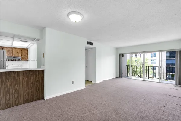 a view of an empty room with a window
