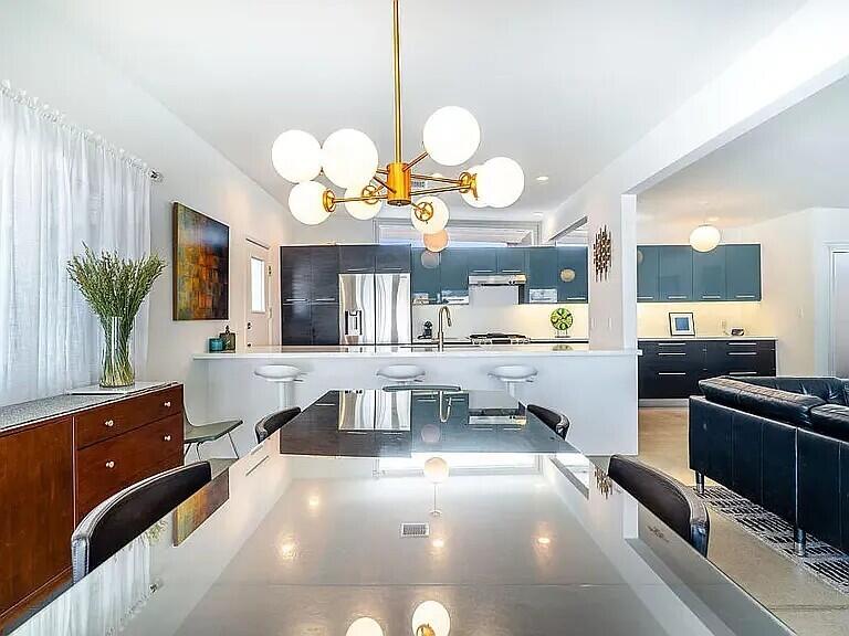 2223 North Magnolia Road Palm Springs, CA 92262 - Photo 11 of 28 a kitchen with a chandelier a stove and cabinets