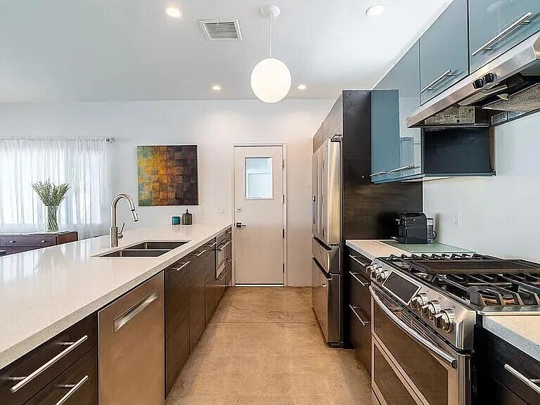 2223 North Magnolia Road Palm Springs, CA 92262 - Photo 14 of 28 a kitchen with stainless steel appliances granite countertop a sink and a stove