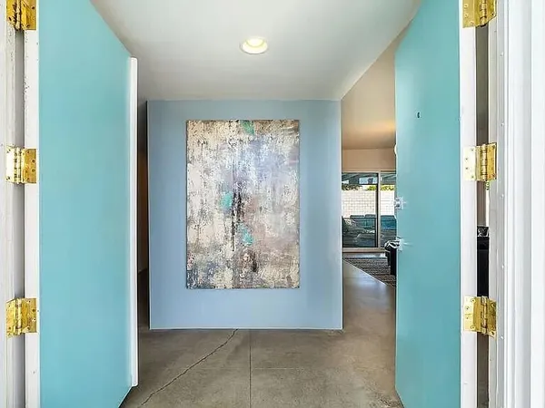 a view of a hallway with paintings on the wall