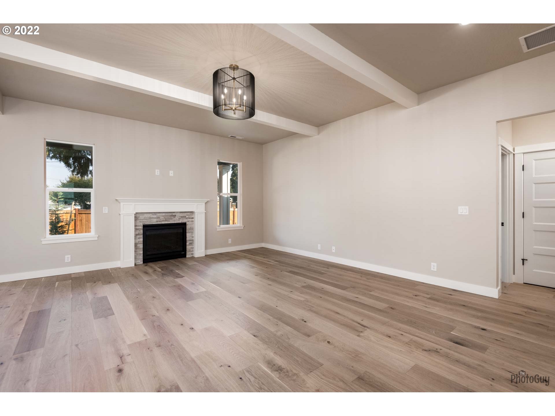 1011 South 33rd Springfield, OR 97478 - Photo 5 of 32 a view of empty room with wooden floor and fireplace
