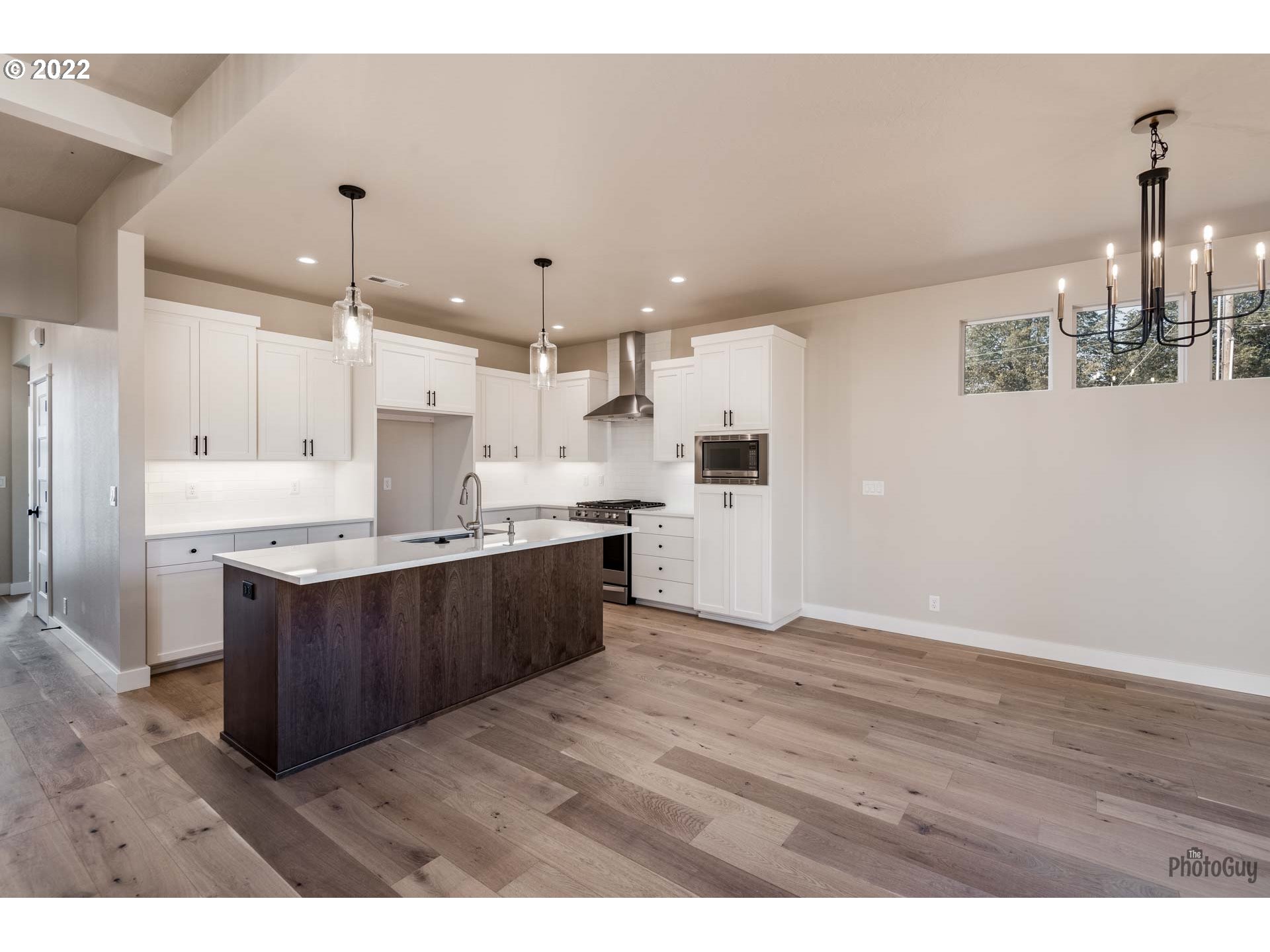1011 South 33rd Springfield, OR 97478 - Photo 8 of 32 a kitchen with kitchen island stainless steel appliances a sink cabinets and wooden floor