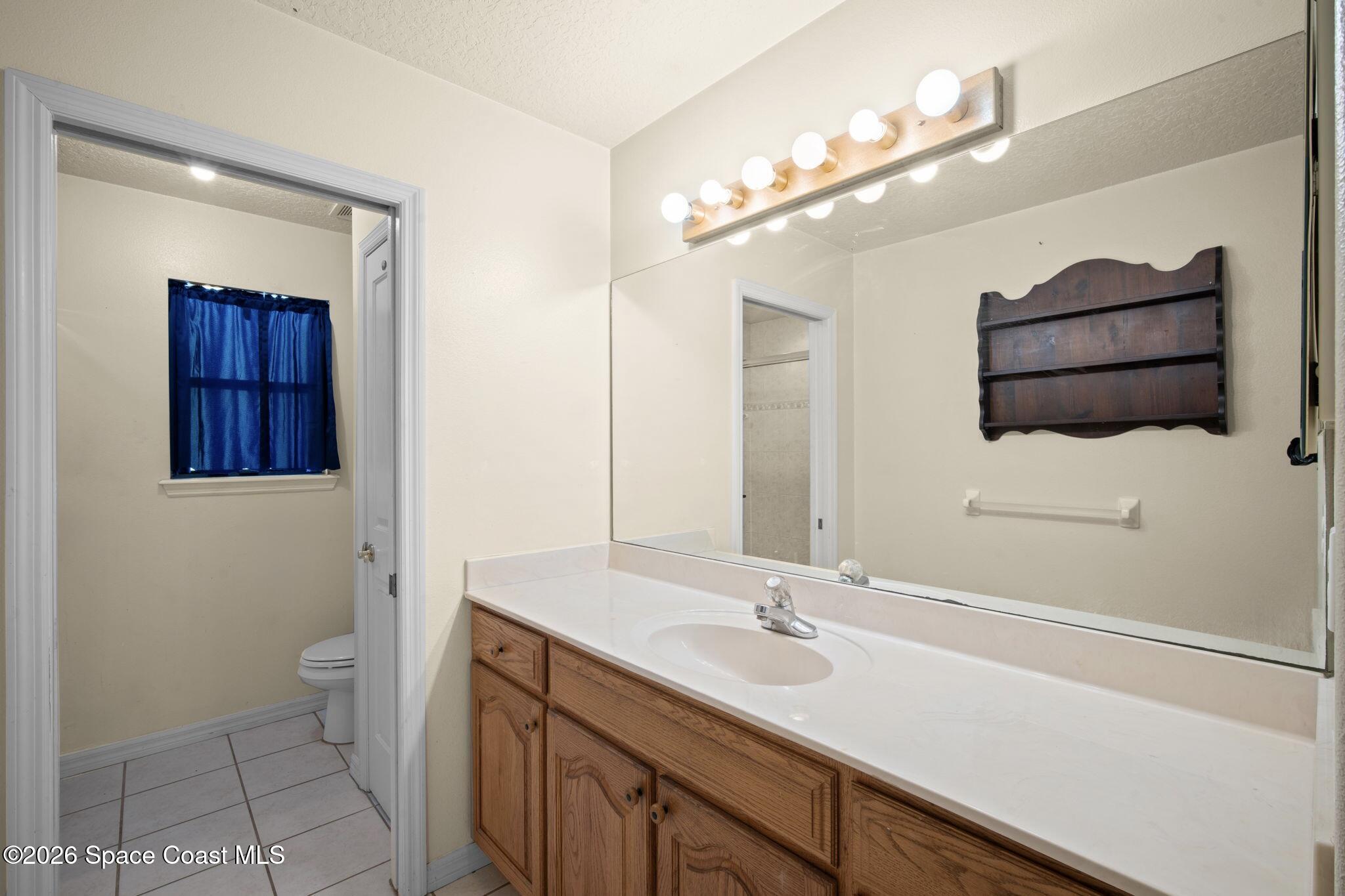 130 North Carpenter Road Titusville, FL 32796 - Photo 14 of 30 Bathroom Ensuite w Pocket door