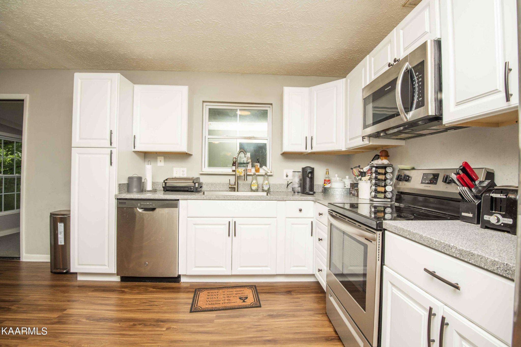 233 Geronimo Road Knoxville, TN 37934 - Photo 8 of 40 a kitchen with stainless steel appliances granite countertop a sink a stove a microwave and cabinets