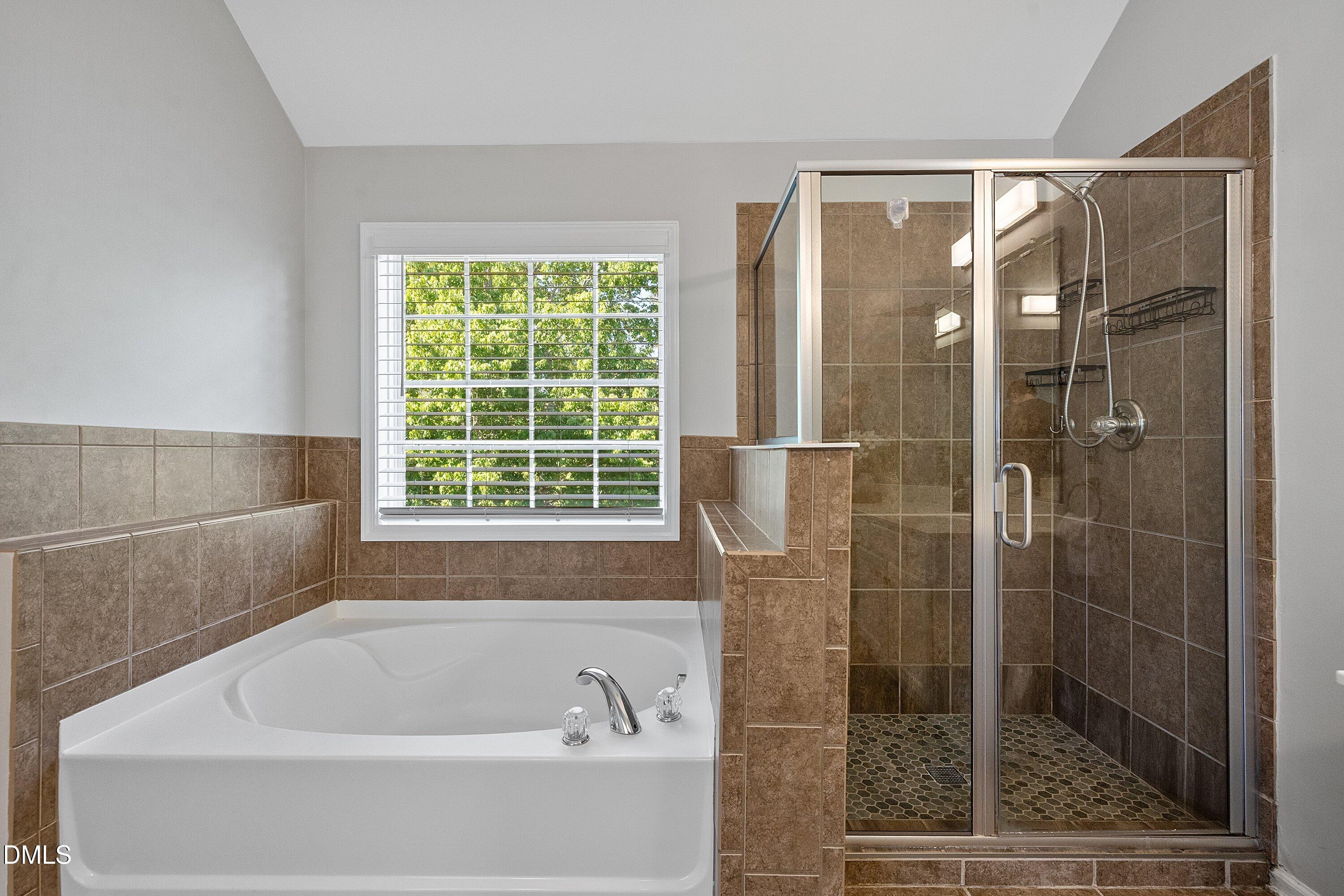 3717 Windmeade Road Wake Forest, NC 27587 - Photo 33 of 51 a bathroom with a bathtub and shower
