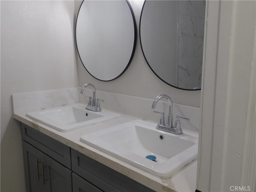 10456 Napa Road Adelanto, CA 92301 - Photo 16 of 31 a bathroom with a sink and a mirror