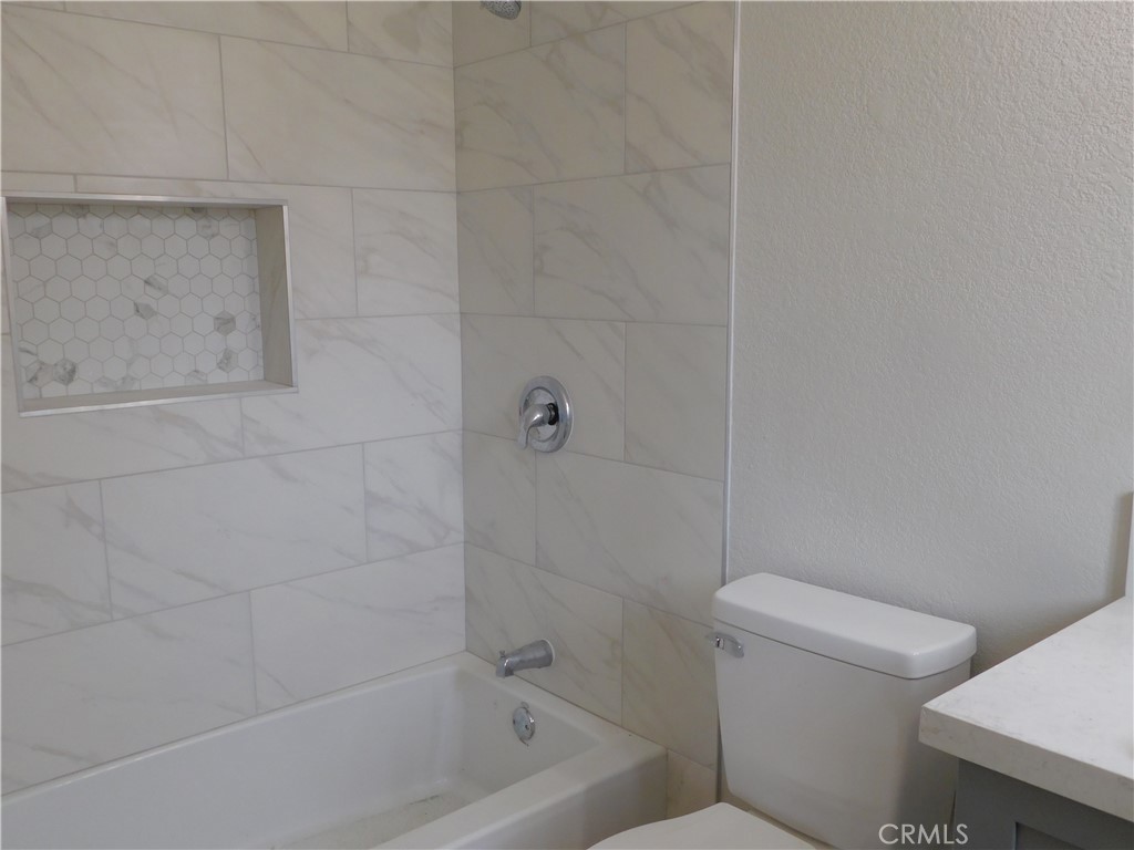 10456 Napa Road Adelanto, CA 92301 - Photo 17 of 31 a white toilet sitting next to a bath tub