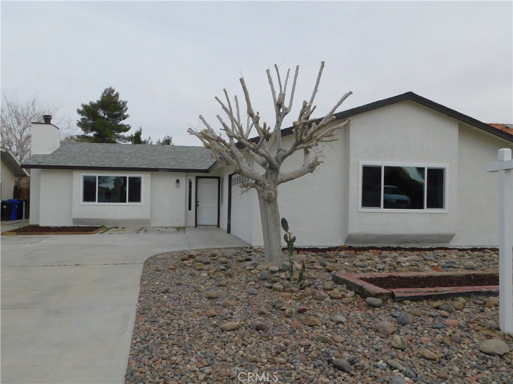 10456 Napa Road Adelanto, CA 92301 - Photo 2 of 31 a front view of a house with a yard