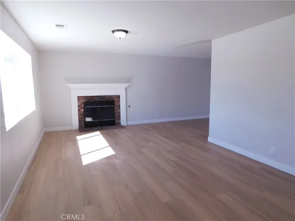 a view of a room with wooden floor