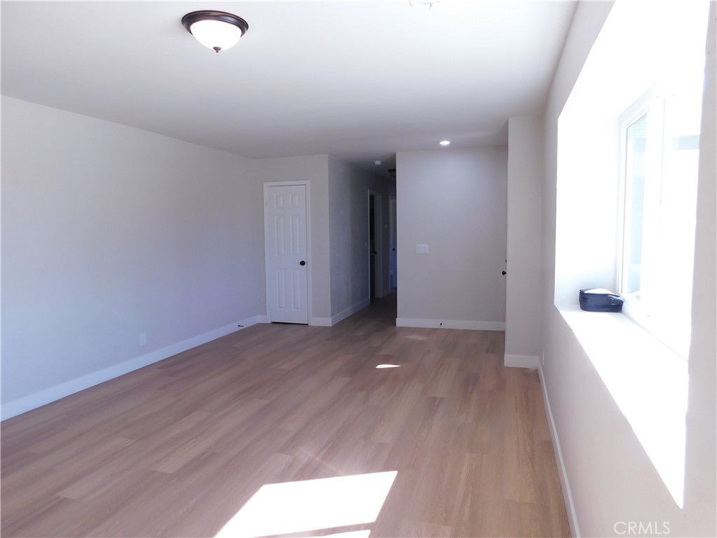10456 Napa Road Adelanto, CA 92301 - Photo 8 of 31 a view of a room with wooden floor