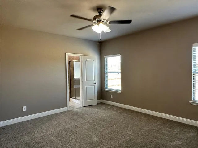 an empty room with a chandelier fan and a chandelier fan